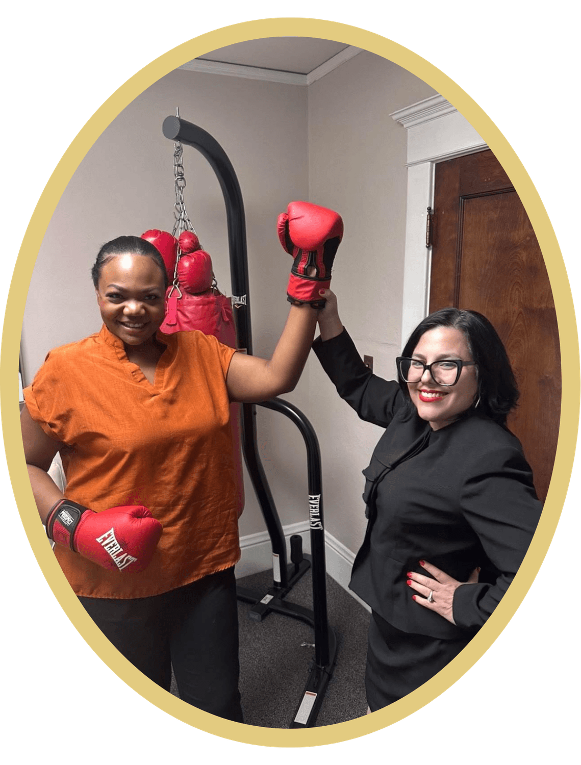 Attorney Tirado celebrating with a client in boxing gloves